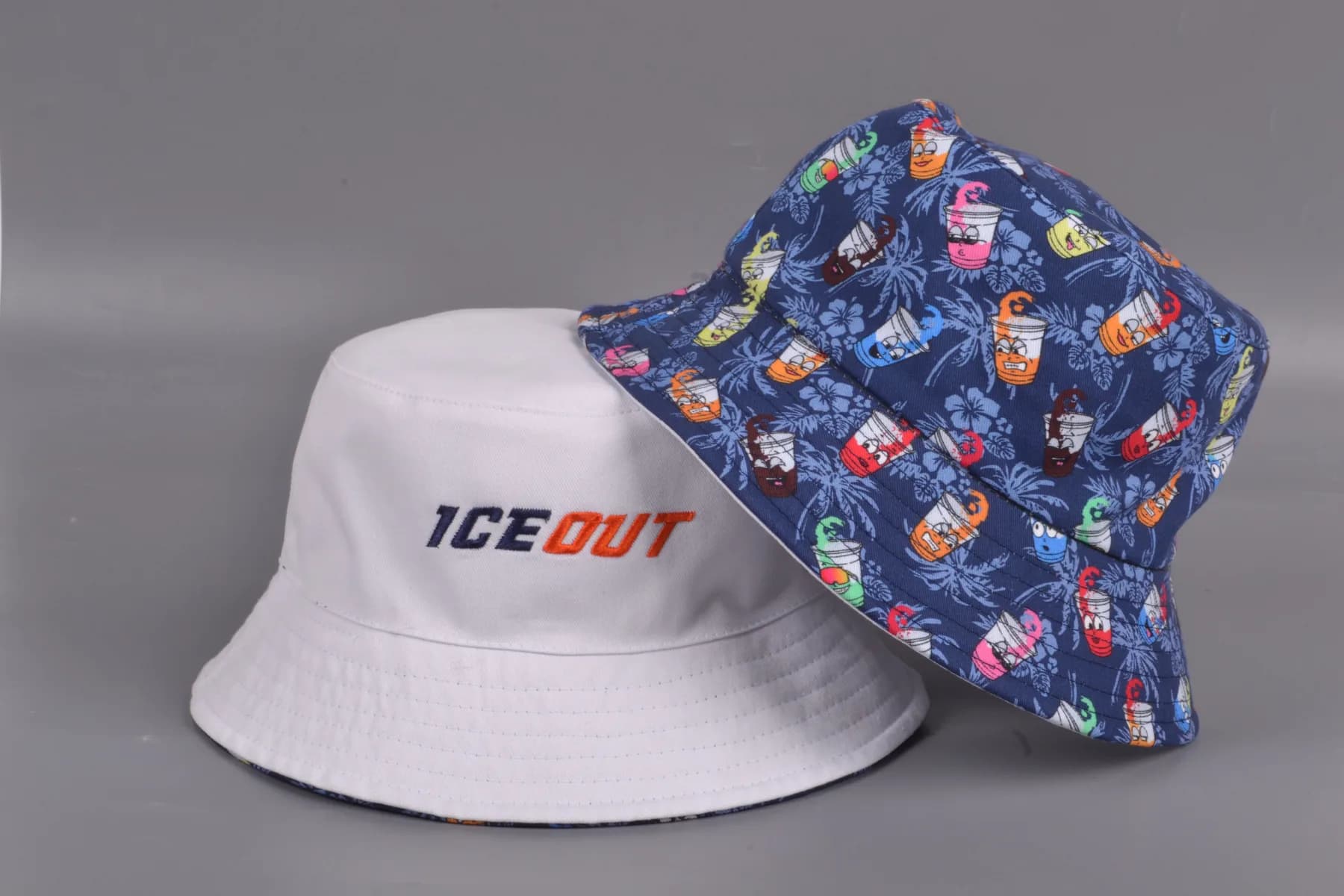 Reversible Ice-Out bucket hat, one side plain with embroidered ICE OUT, the reverse a printed pattern.