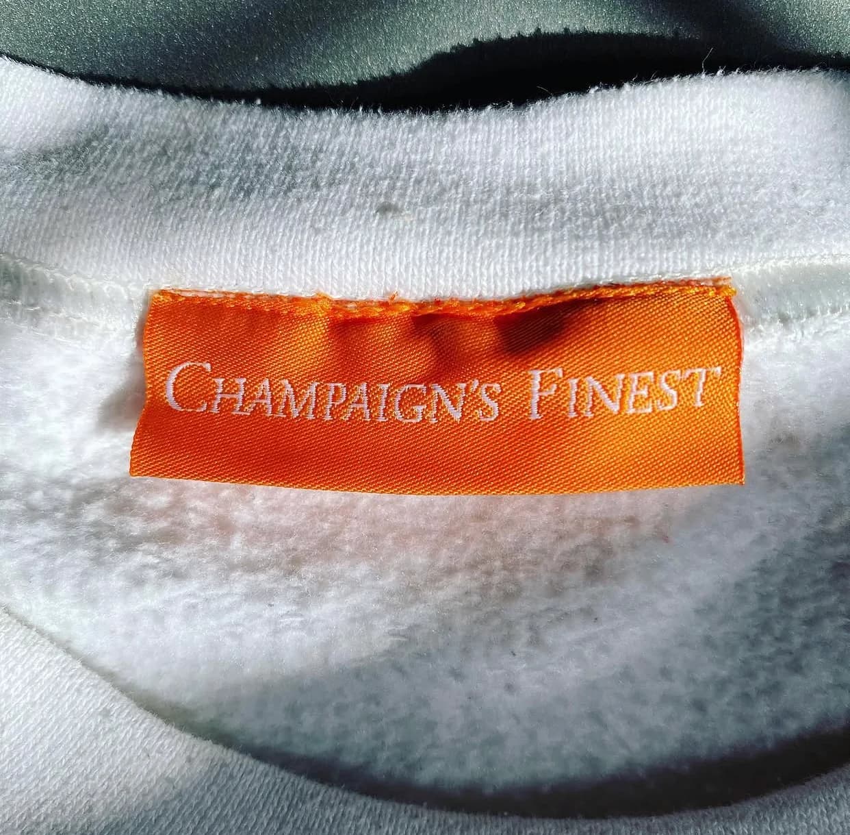 Custom woven Champaign's Finest label sewn into a garment.